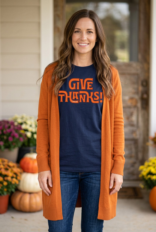 Navy Give Thanks shirt mockup with a long-haired woman wearing an open orange cardigan